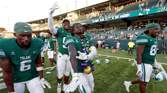 Tulane football players celebrate after a win over Memphis.